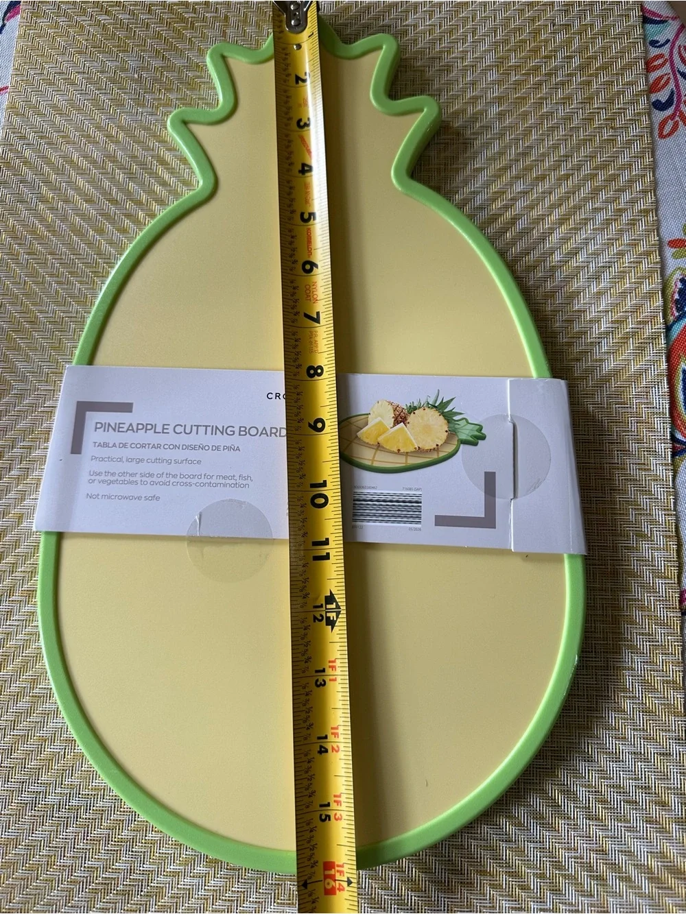 Croton Pineapple-Shaped Cutting Board in Yellow with Green Trim and Colander.